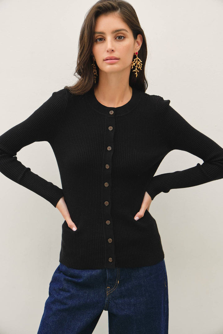 A model wearing a black CAL JUNE slim-fit ribbed cardigan with a crew neckline and button-front closure.
