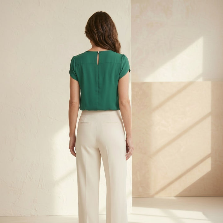 CAL JUNE The Arden Blouse in emerald green, a refined and feminine short-sleeve top.