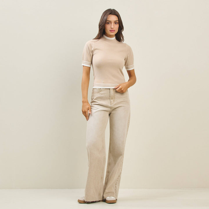 CAL JUNE The Arden Knit Top in beige, a short-sleeve mock neck sweater with white striped trim.