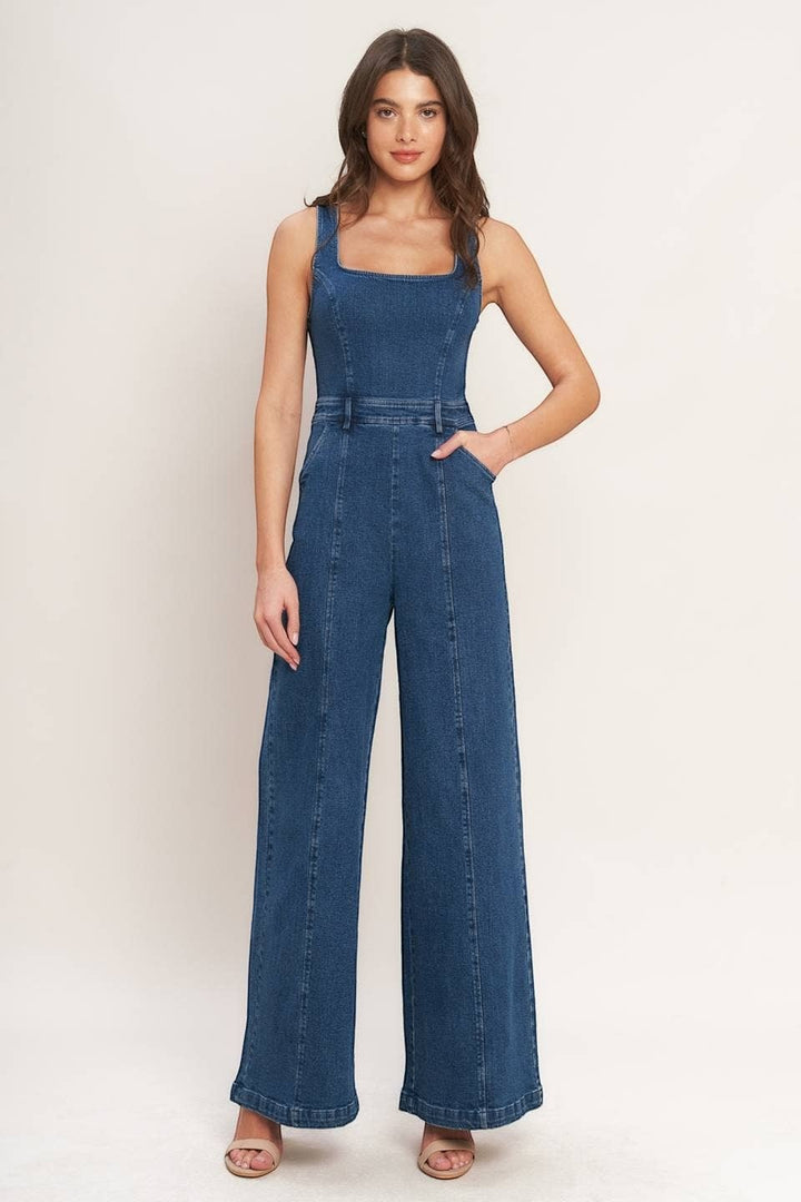 CAL JUNE Ari Denim Jumpsuit in medium wash blue with square neckline and wide legs. Model is wearing size Small.