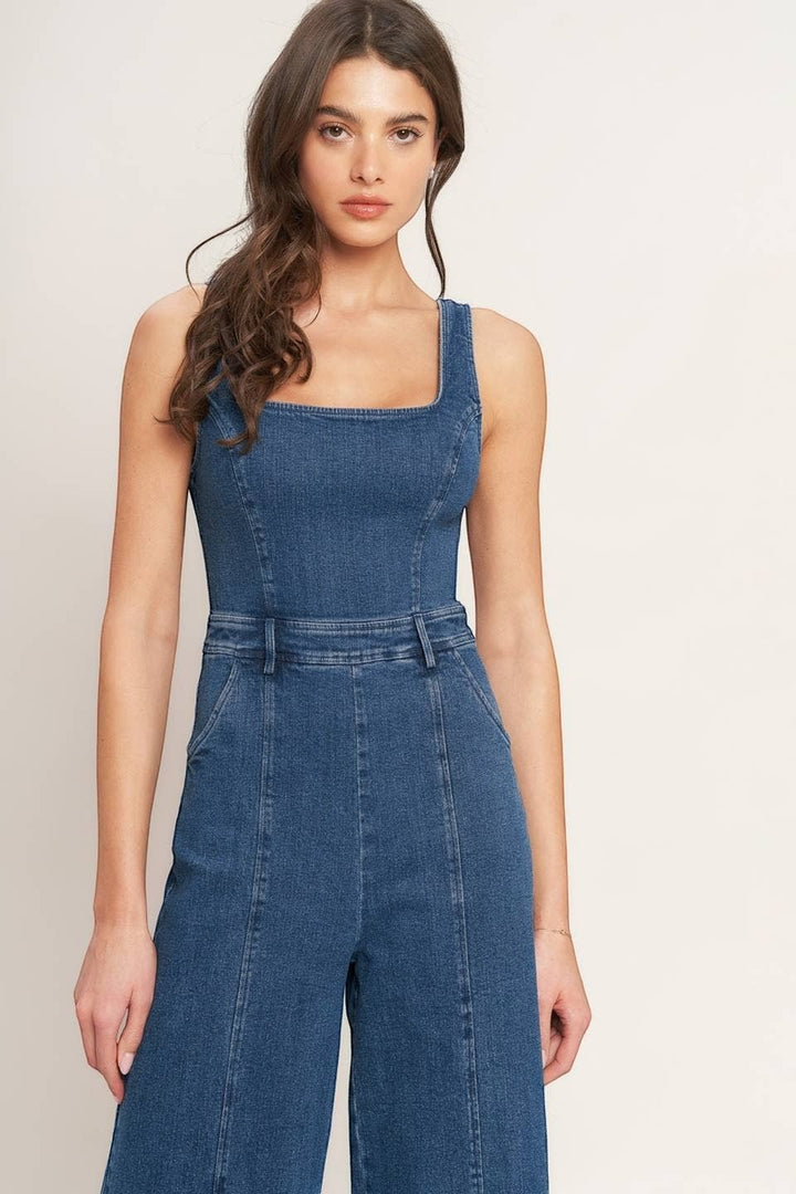 CAL JUNE Ari Denim Jumpsuit with square neckline and wide leg pants. Model wears size Small.