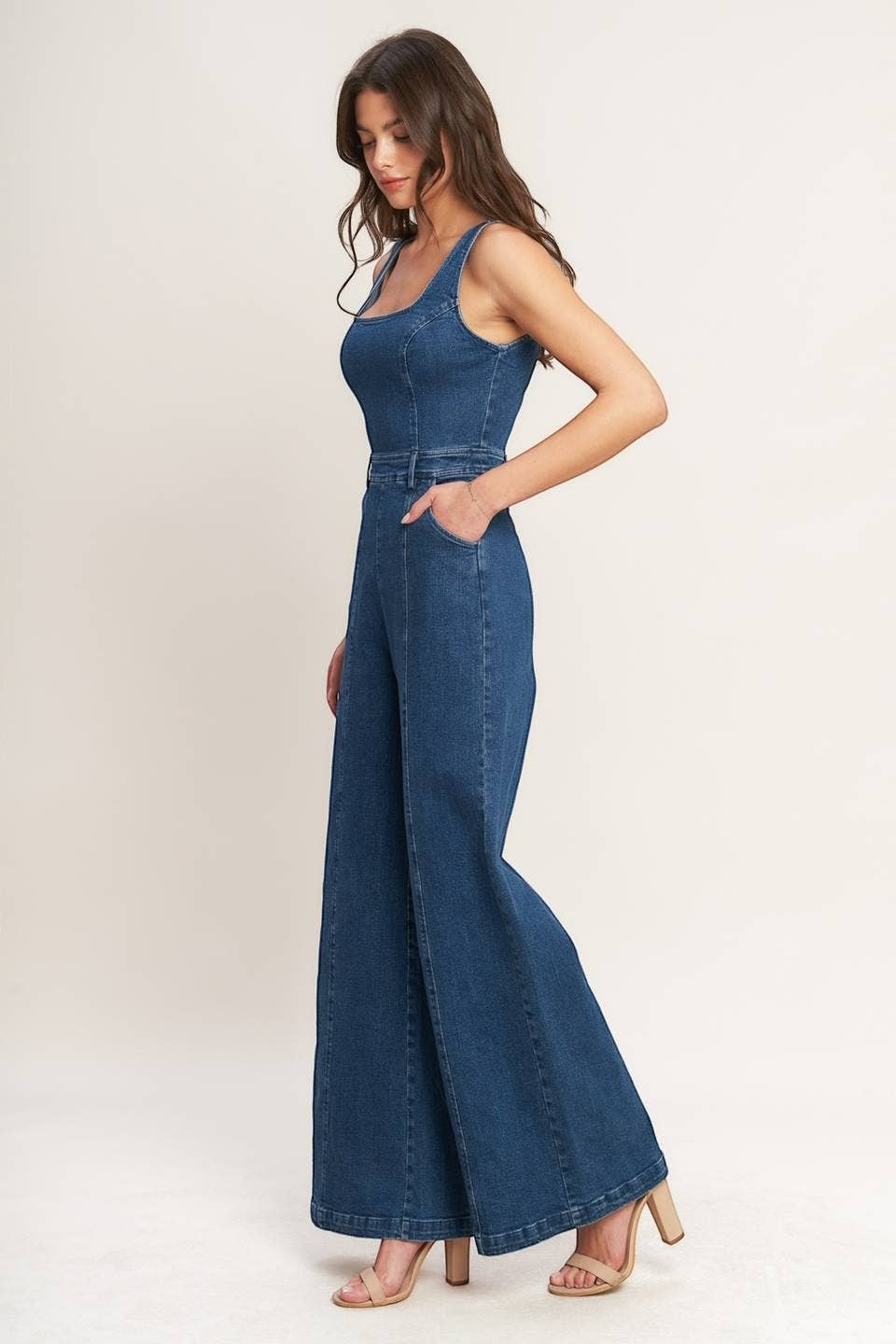 CAL JUNE Ari Denim Jumpsuit in dark wash blue, featuring a scoop neck and wide leg silhouette. Model wears size S.