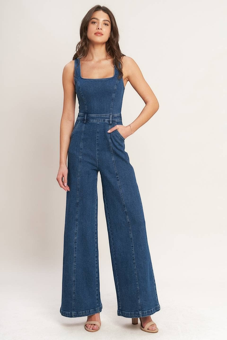 CAL JUNE Ari Denim Jumpsuit, a sleeveless dark wash denim jumpsuit with a square neckline and wide legs.
