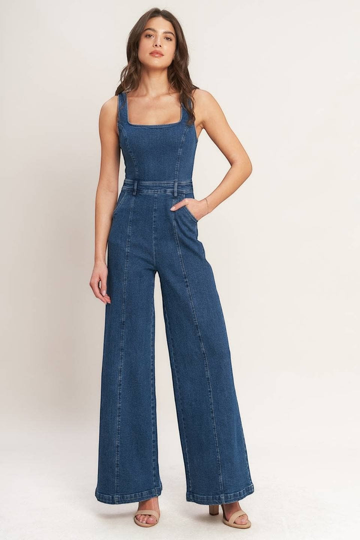 CAL JUNE Ari Denim Jumpsuit, a sleeveless dark wash denim jumpsuit with a square neckline and wide legs.