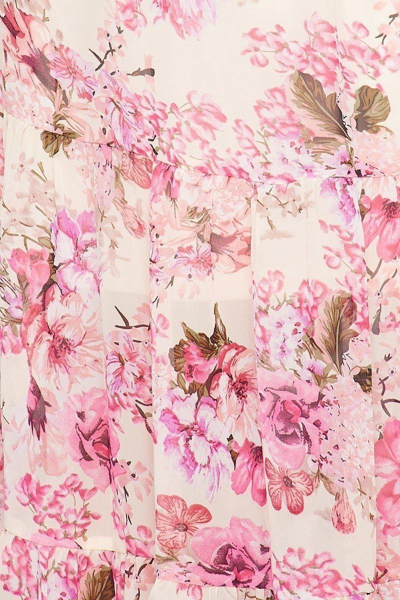 CAL JUNE Arielle off-shoulder maxi dress with pink and purple floral print on cream fabric. Tiered skirt, flutter sleeves.