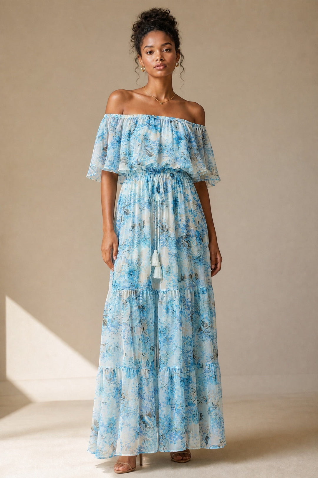 CAL JUNE Arielle off-shoulder maxi dress with blue floral print, flutter sleeves, and tassel drawstring waist.