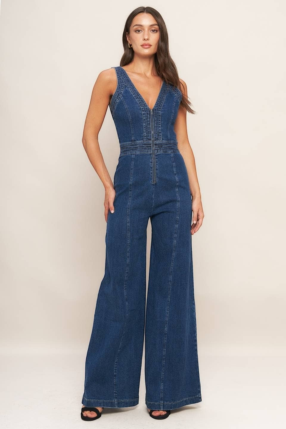 CAL JUNE blue denim wide-leg jumpsuit with V-neck and front zipper. Model wears size Small.