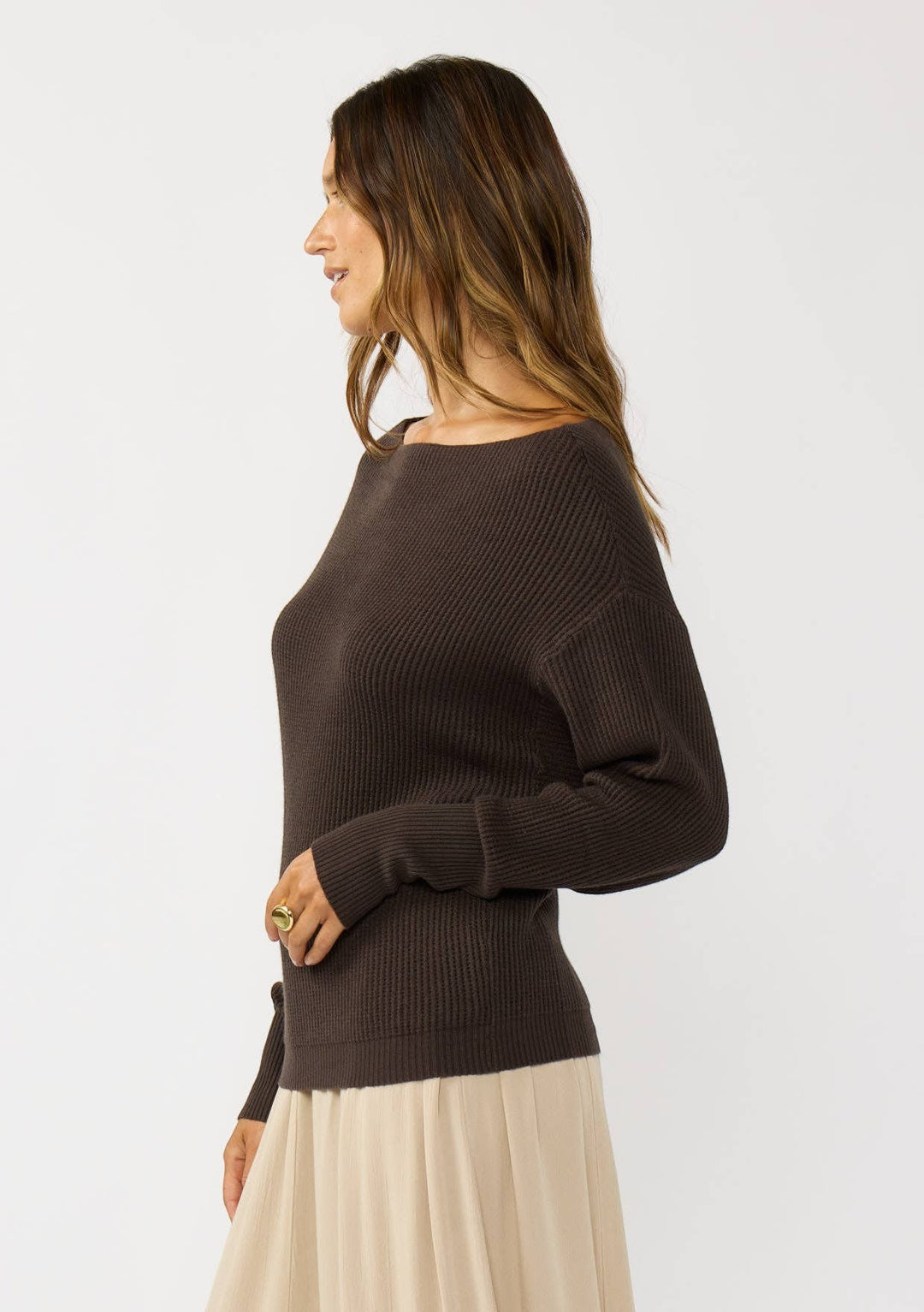 CAL JUNE The Avery Knit Top in dark brown, a ribbed boatneck sweater with long sleeves, worn by a model.