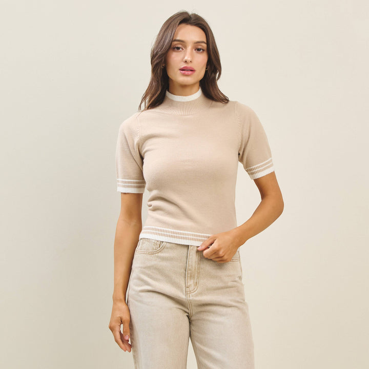 CAL JUNE beige knit top with mock neck and short sleeves, featuring white stripe details on cuffs and hem.