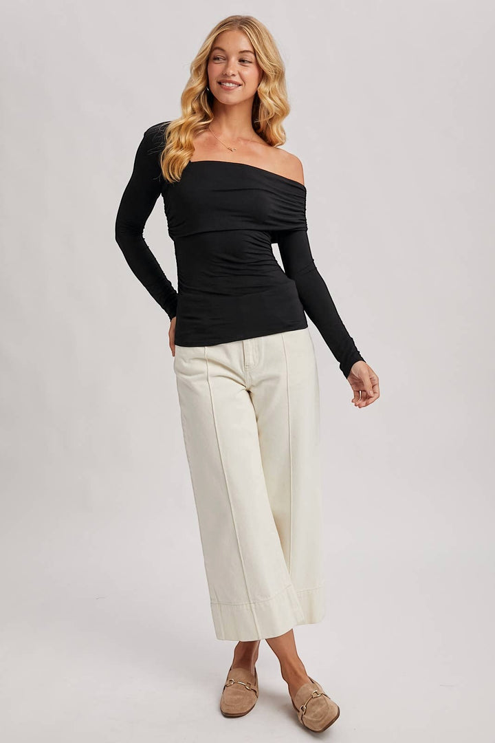 CAL JUNE black rayon-spandex knit top with asymmetric neckline and ruched detailing. Long sleeves.
