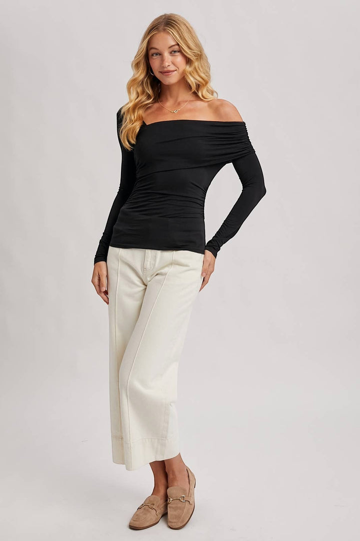 CAL JUNE black rayon-spandex knit top with asymmetric neckline and ruched detailing. Long sleeves, off-the-shoulder style.