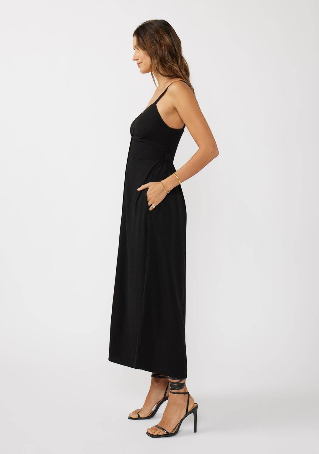 CAL JUNE black maxi dress with ruched sides, spaghetti straps, and pockets. Model wears size S.