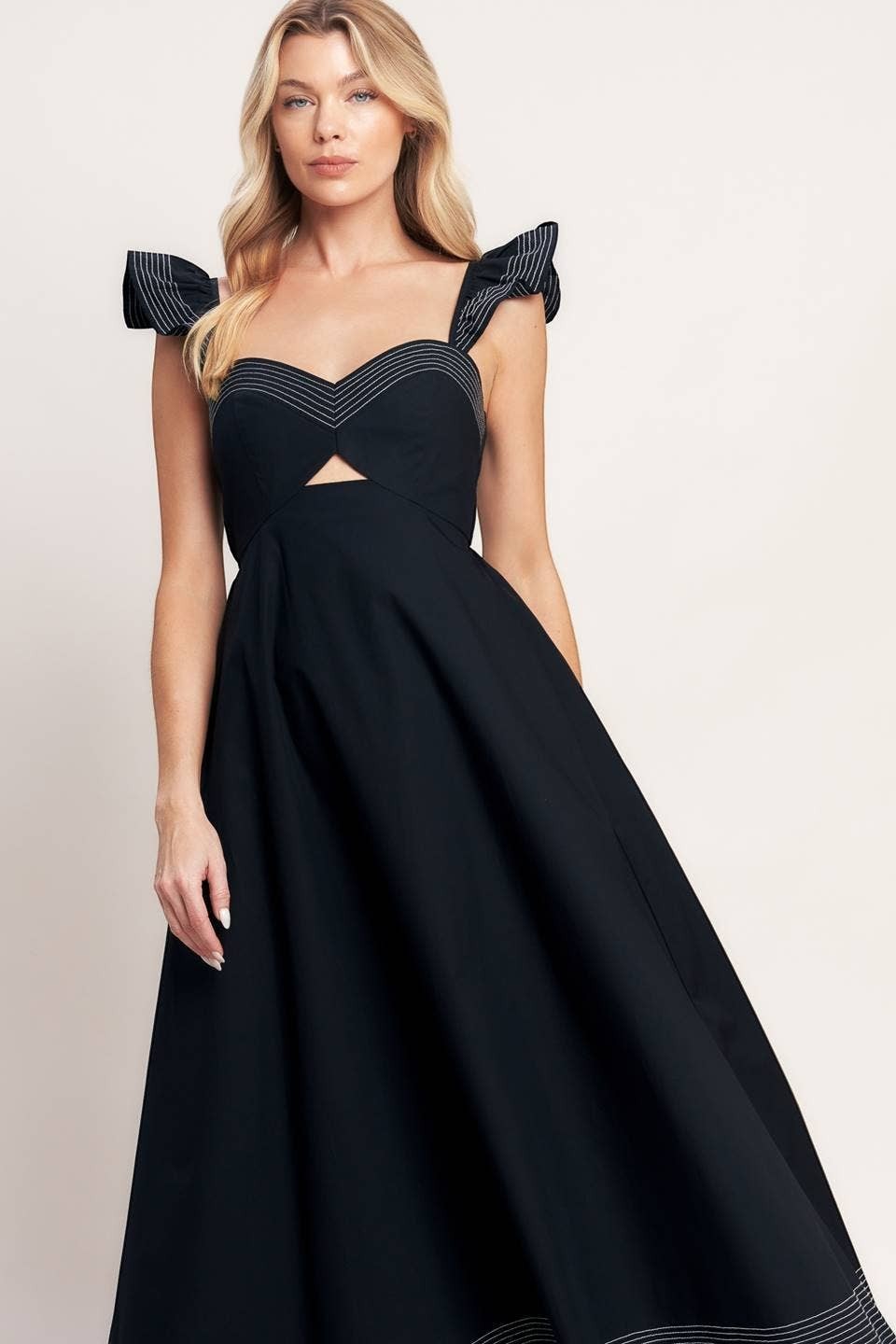 CAL JUNE black midi dress with sweetheart neckline, cutout detail, and ruffled sleeves with contrast stitching.