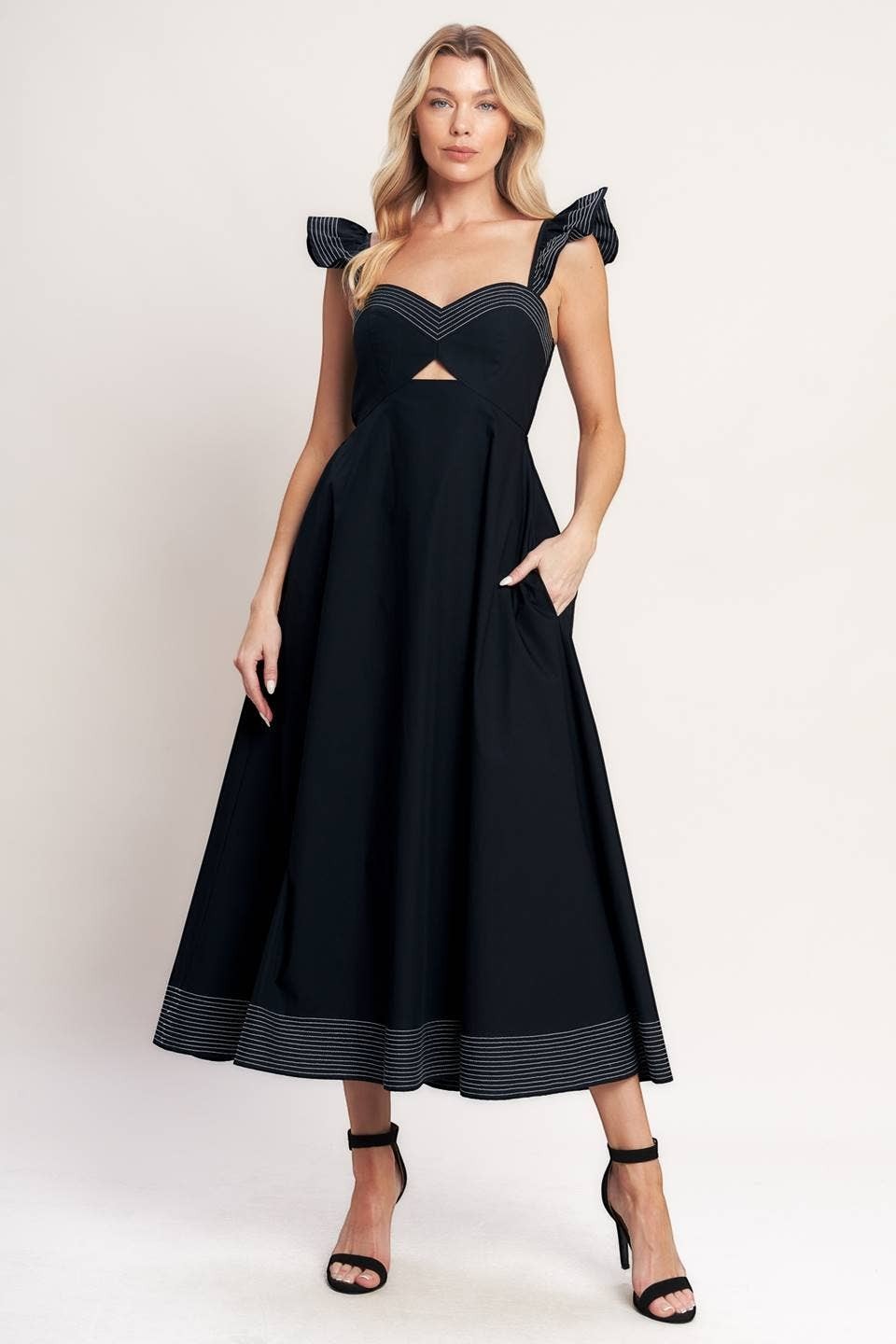 CAL JUNE black midi dress with sweetheart neckline, cut-out detail, ruffled straps, and contrast stitching on hem. Model is wearing size Small.