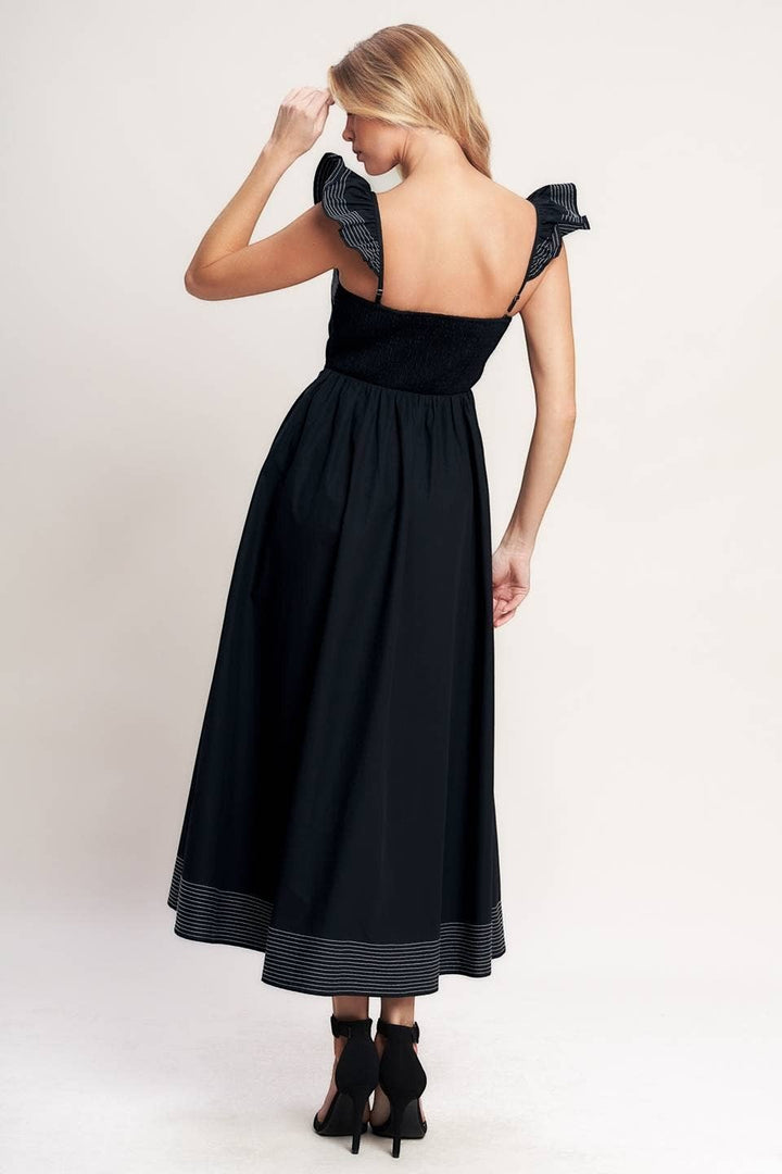 CAL JUNE black midi dress with smocked bodice, ruffled straps, and contrast stitching detail on hem.