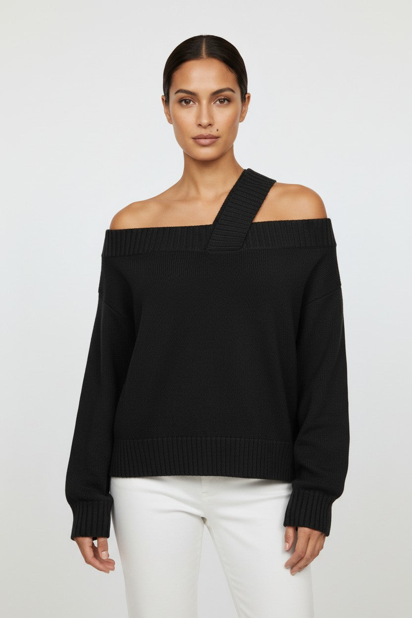 Model wearing a black CAL JUNE Katarina off-shoulder knit top with a unique asymmetrical strap detail.