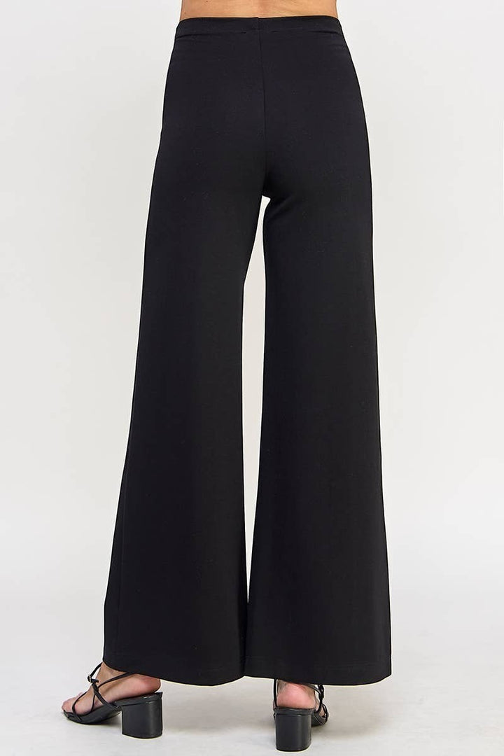 CAL JUNE black ponte wide-leg pants designed to elongate the silhouette. Model is wearing size Small.