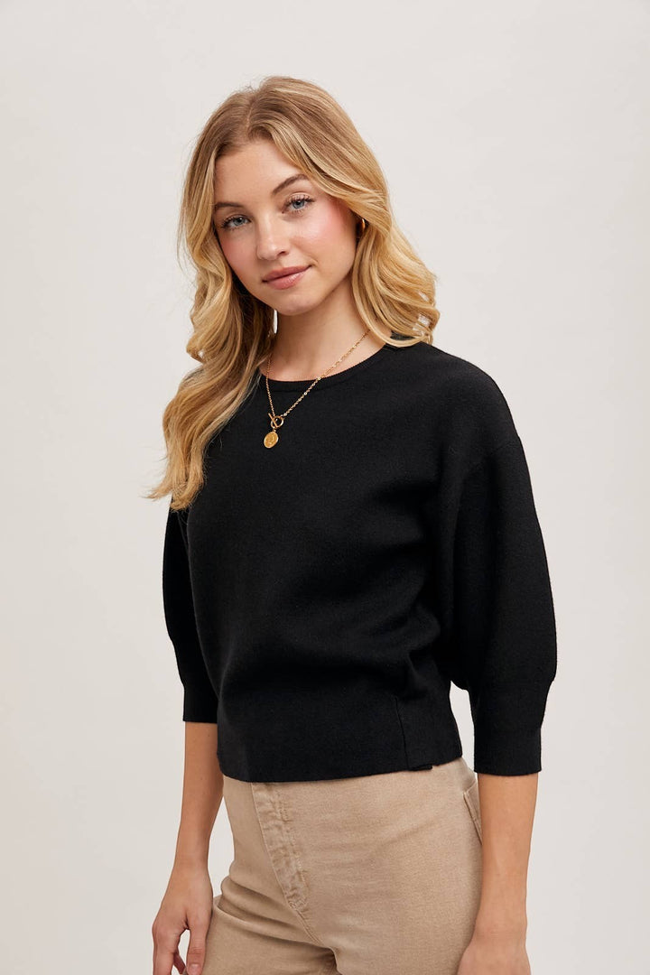 CAL JUNE black knit top with three-quarter puff sleeves and crew neck. Model wears size Small.