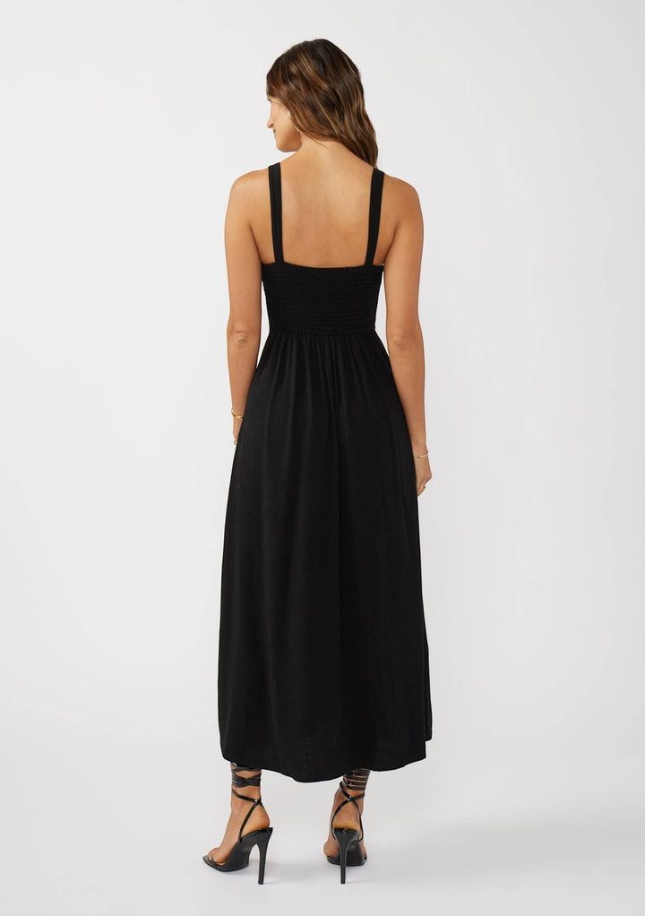 CAL JUNE black smocked bodice maxi dress with wide straps and flowing skirt. Model wears size S.