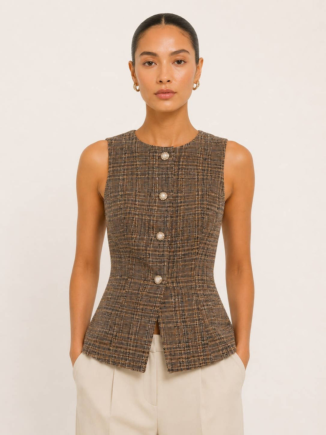 Model wearing a CAL JUNE brown tweed sleeveless vest with pearl-inspired buttons and a fitted silhouette.