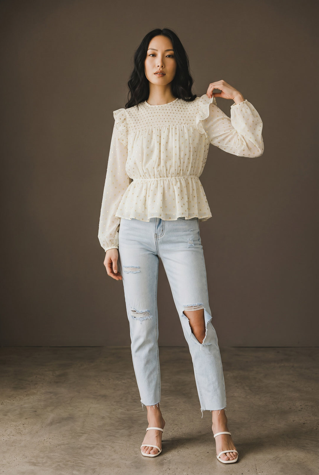CAL JUNE cream sheer blouse with gold polka dots, smocked bodice, ruffled shoulders, and peplum hem.
