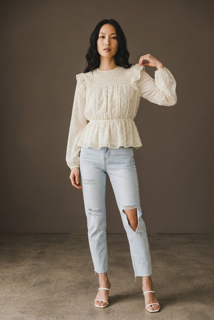 CAL JUNE cream sheer blouse with gold polka dots, smocked bodice, ruffled shoulders, and peplum hem.