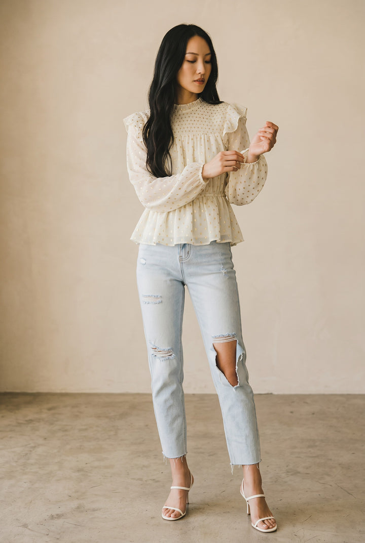 CAL JUNE cream sheer blouse with gold polka dots, smocked bodice, ruffled shoulders, and peplum hem.