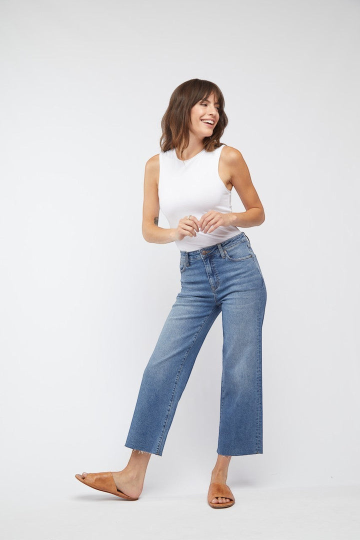 CAL JUNE The Daisy Cropped High-Rise Jean in vintage worn wash. Wide leg, cropped raw hem, made from recycled cotton with 1% stretch.