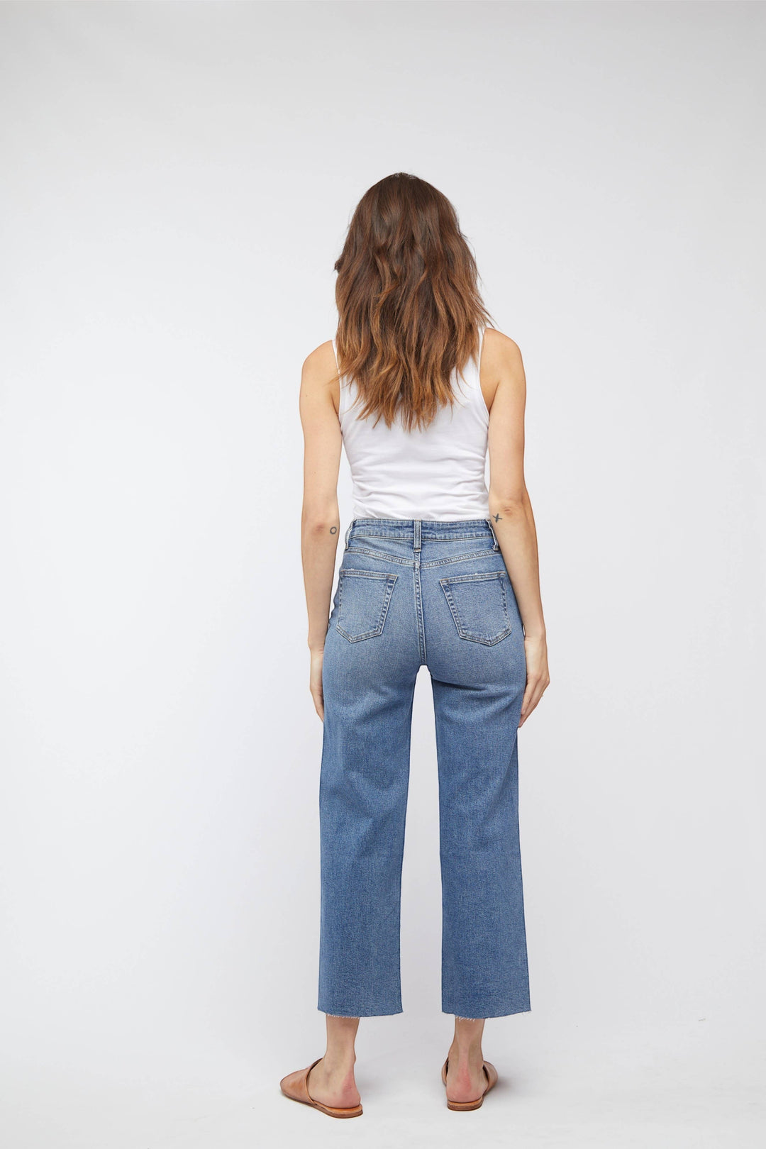 CAL JUNE The Daisy Cropped High-Rise Jean in vintage worn wash. High-rise, wide leg, cropped raw hem.