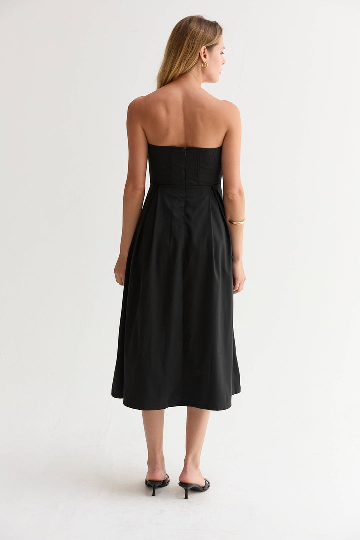 CAL JUNE Elara Strapless Midi Dress in black, featuring a sculpted bodice with boning and a pleated skirt.