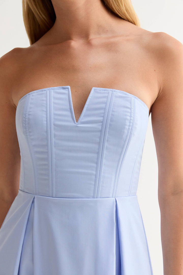 CAL JUNE Elara Strapless Midi Dress in light blue. Features a sculpted bodice with boning and V-wire neckline, and a pleated midi skirt.