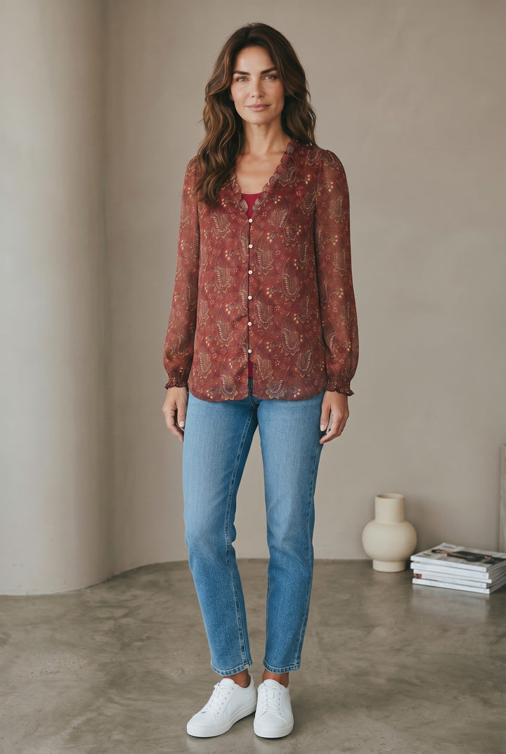 CAL JUNE The Elizabeth Ruffle Blouse in rust paisley print with ruffled neckline and button front. Model wears size S.