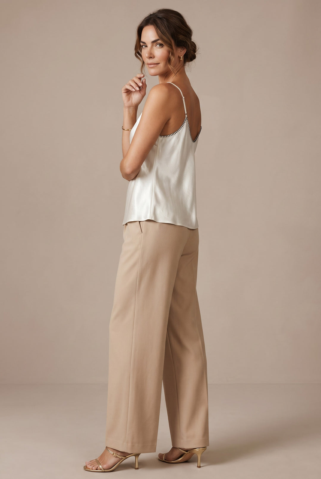 CAL JUNE ivory satin camisole top with black whipstitch trim and adjustable straps.