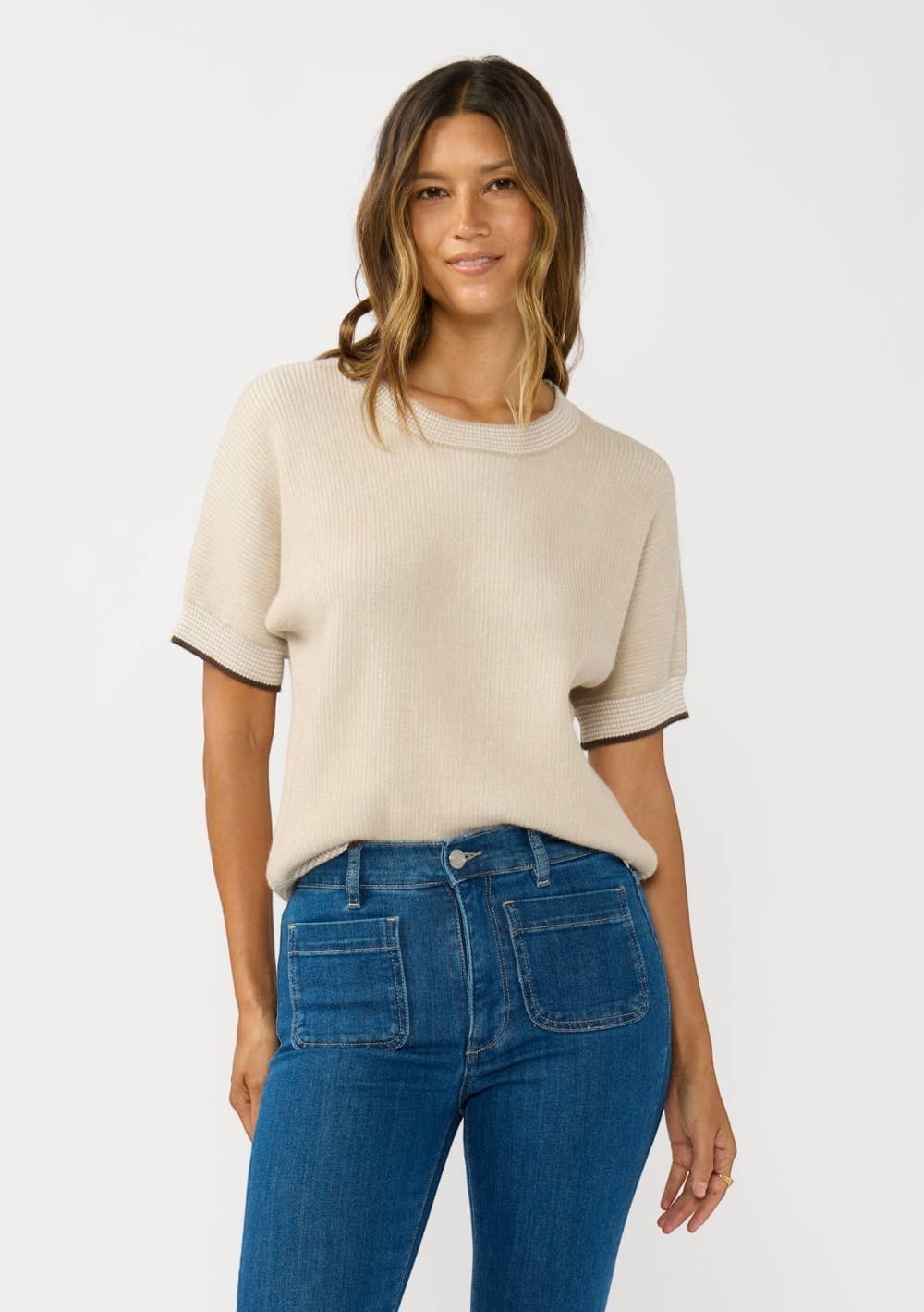 CAL JUNE The Jade Contrast Trim Top in beige knit with short sleeves and dark trim detail. Model wears size S.