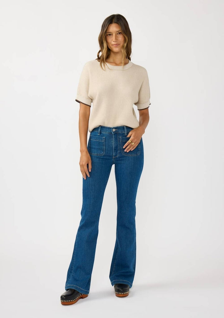 CAL JUNE The Jade Contrast Trim Top in beige knit with dark trim on sleeves and neckline. Model wears size S.