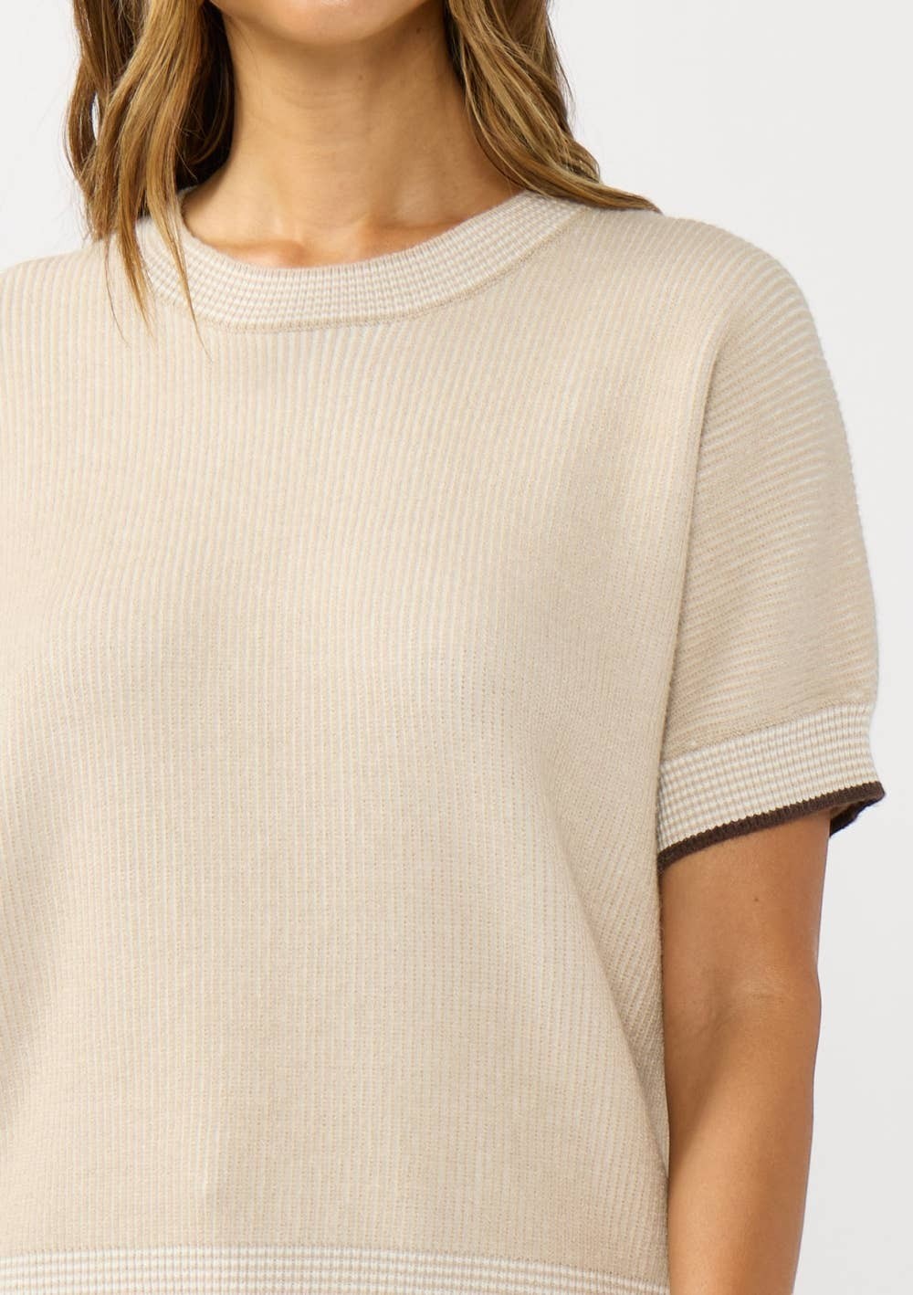 CAL JUNE The Jade Contrast Trim Top in beige knit with brown trim detail on sleeves and hem.