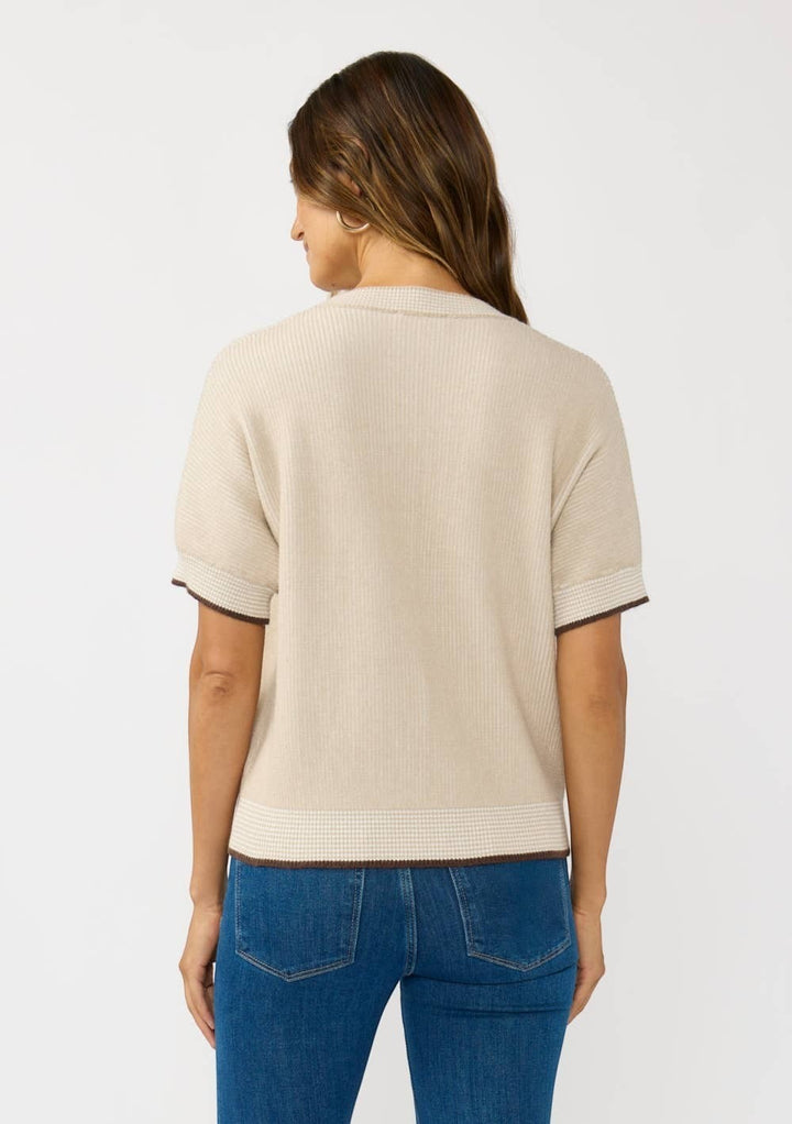 CAL JUNE The Jade Contrast Trim Top, a short-sleeve knit sweater in beige with brown trim and a subtle checkered hem detail.