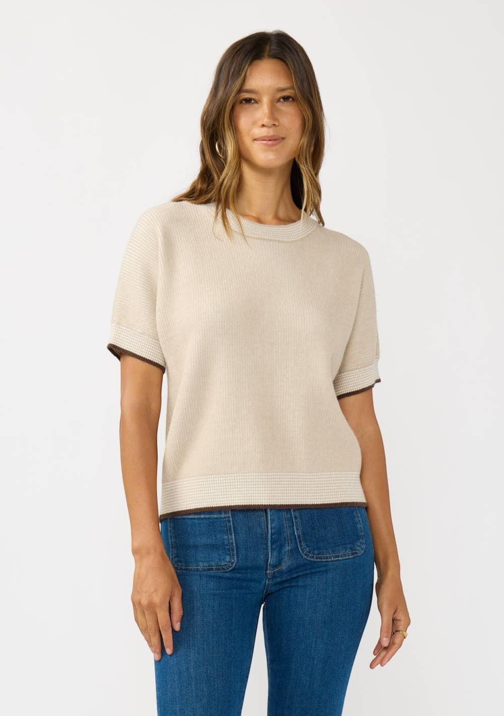 CAL JUNE The Jade Contrast Trim Top, a short-sleeve knit sweater in beige with brown trim and a subtle checkered pattern at the hem.