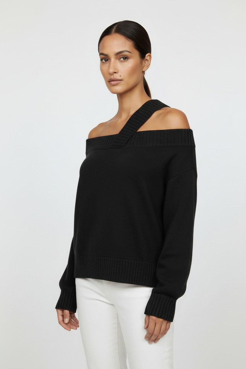 Model wearing a black CAL JUNE Katarina off-shoulder knit top with a ribbed neckline and hem.