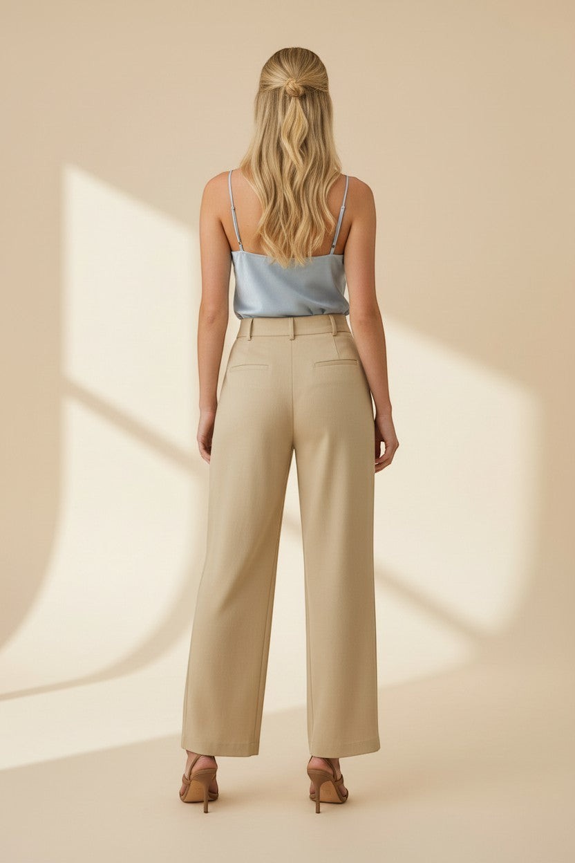 CAL JUNE light blue satin camisole top with spaghetti straps and cowl neck, paired with beige wide-leg trousers.