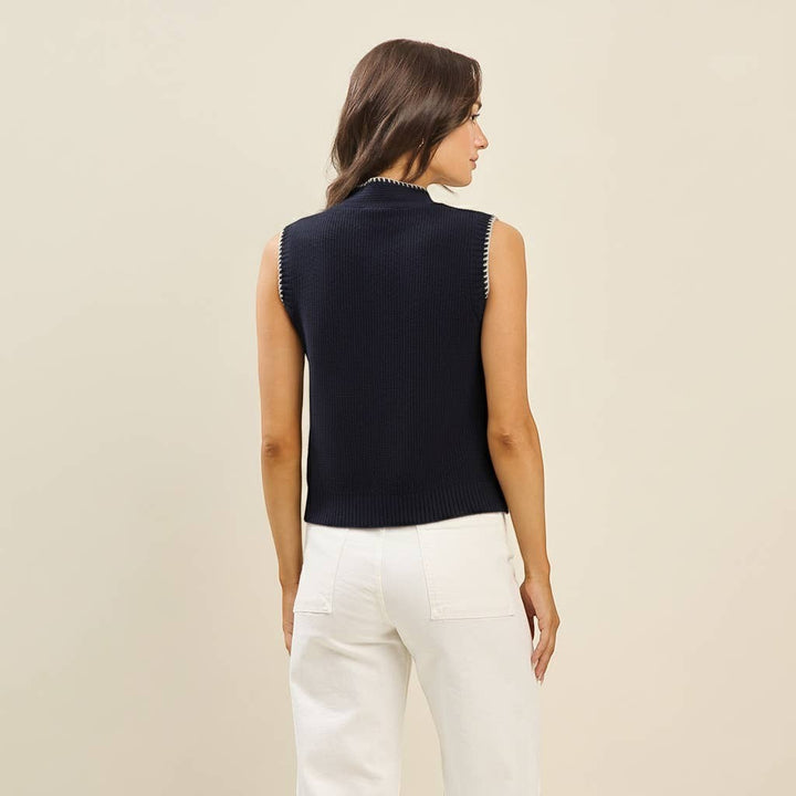 CAL JUNE navy blue knit sweater vest with mock neck and whipstitch trim. Model wears size Small.