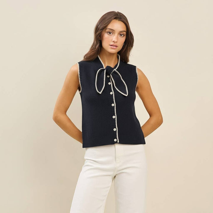 CAL JUNE navy knit sweater vest with white whipstitch trim and bow detail. Model wears size S.