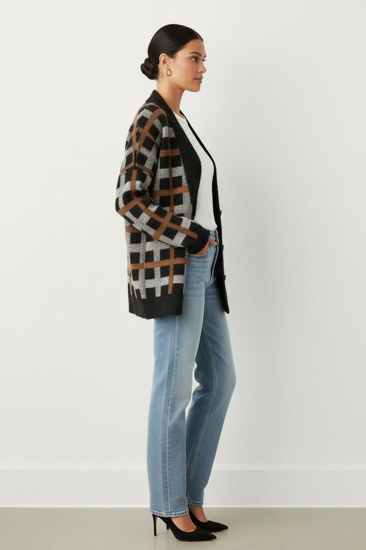 CAL JUNE Briseis oversized tri-color knit cardigan in black, brown, and grey worn by a model with jeans.