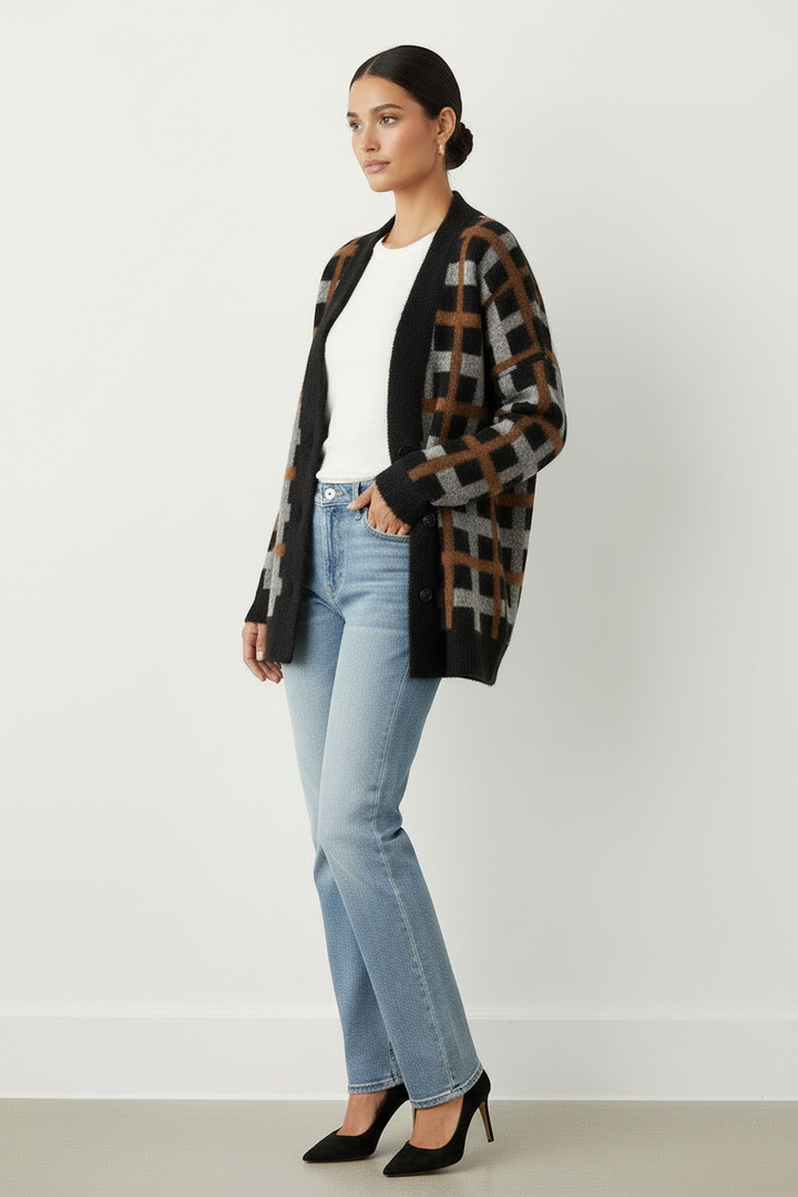 Model wearing CAL JUNE Briseis oversized tri-color plaid knit cardigan with black, brown, and grey pattern