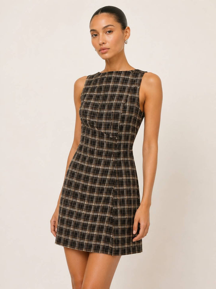 Model wearing a CAL JUNE sleeveless mini dress in a brown and black plaid print with a tailored silhouette.