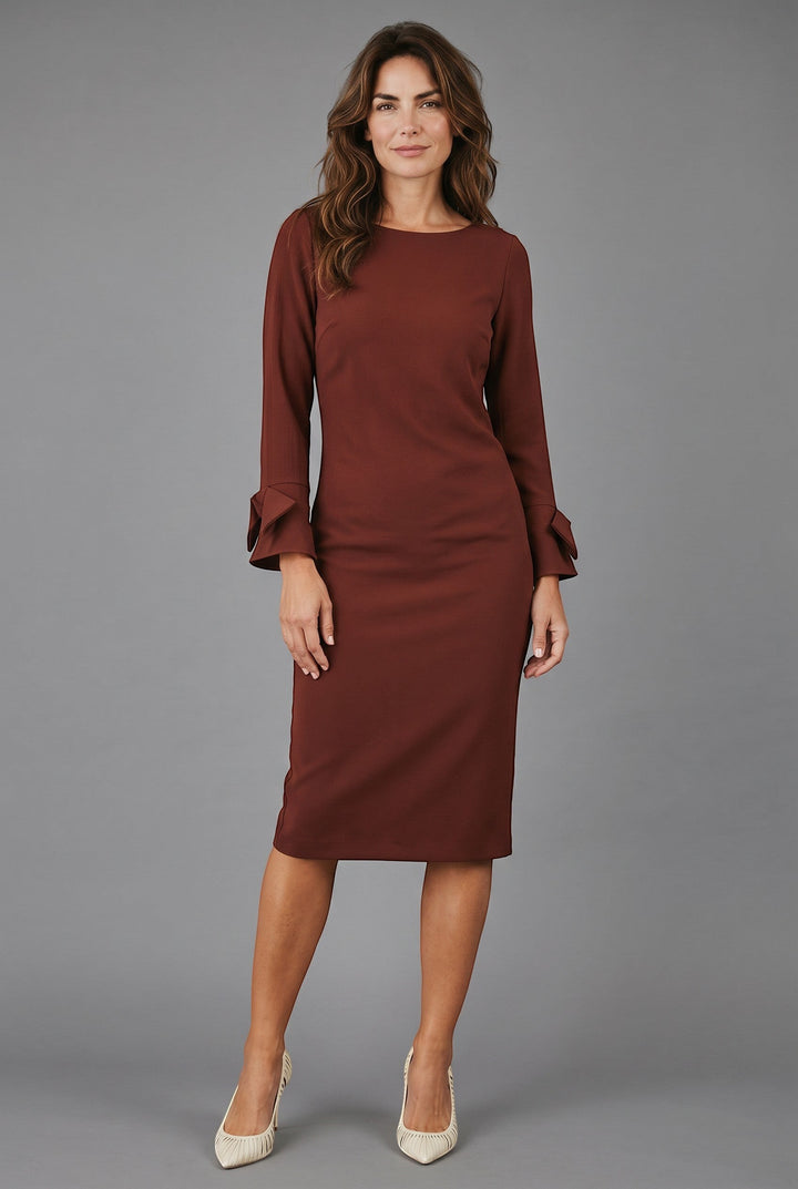 CAL JUNE Sia Midi Dress in deep rust, featuring a boat neckline, long sleeves with bow cuffs, and a tailored fit.