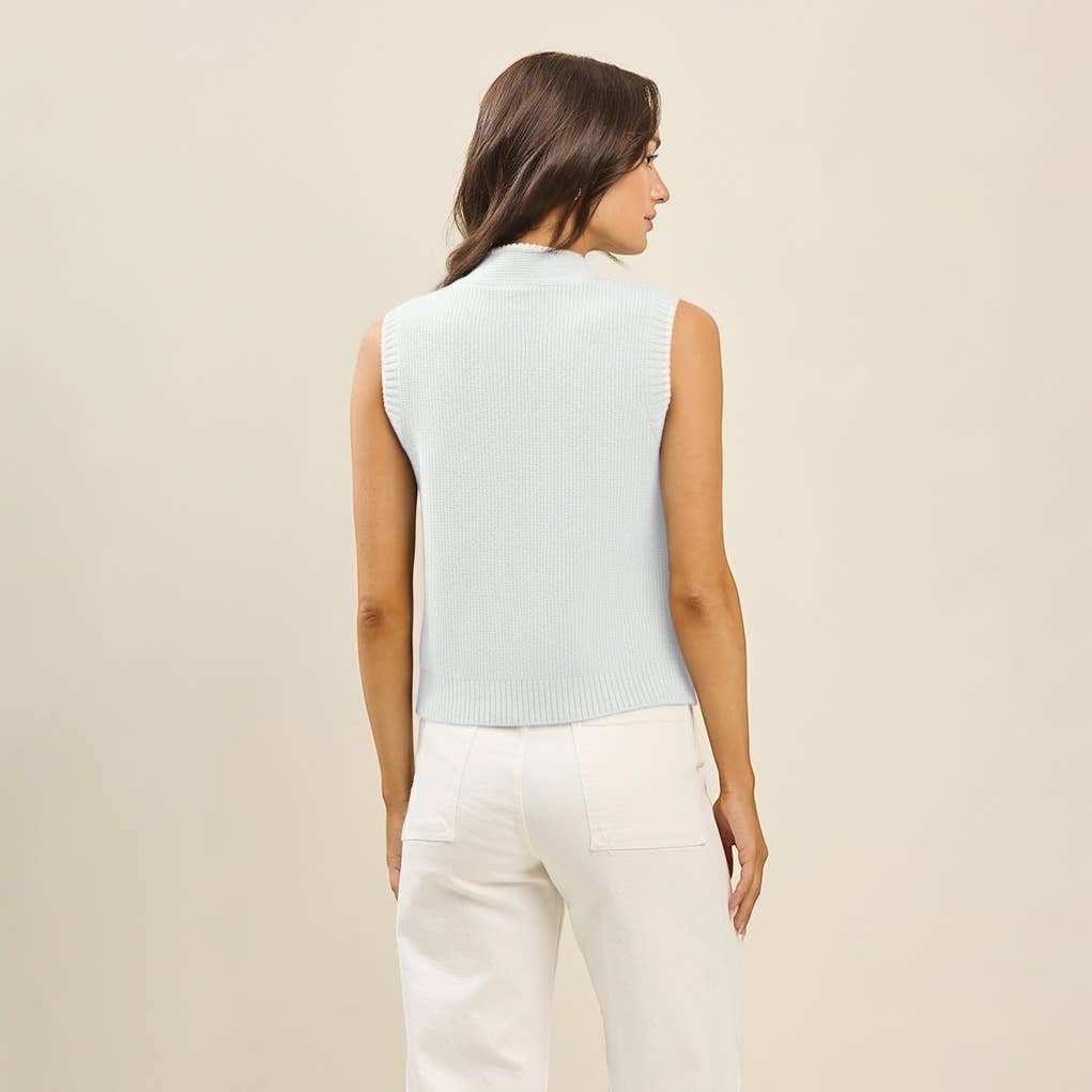CAL JUNE light blue knit sweater vest with mock neck and whipstitch detailing on a model.