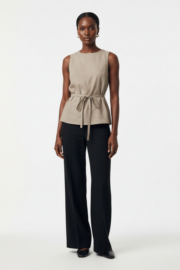 CAL JUNE Ursuline sleeveless taupe tunic top with boat neckline and waist tie worn with black trousers
