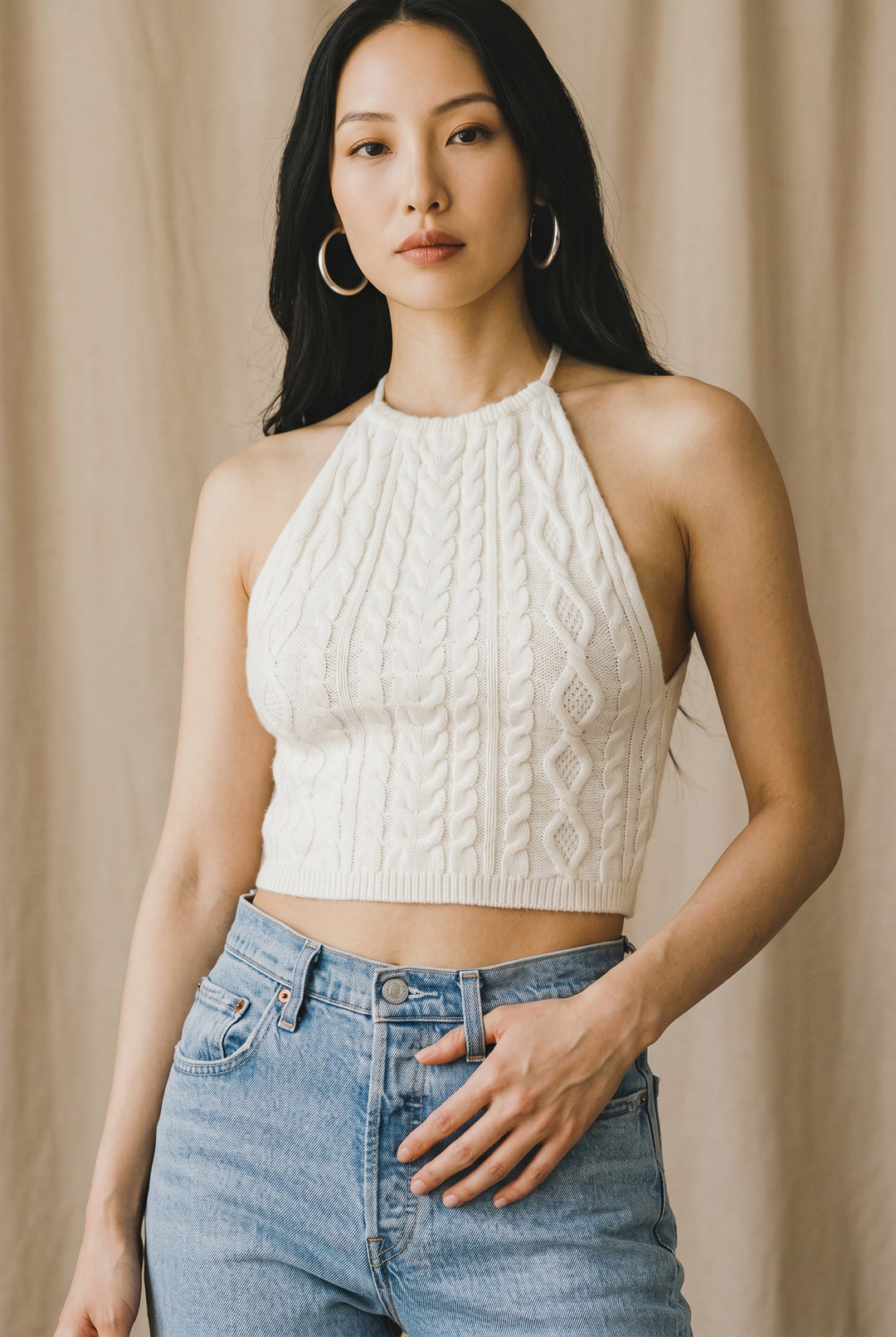 CAL JUNE white cable knit halter crop top with a textured finish. Model wears size Small.