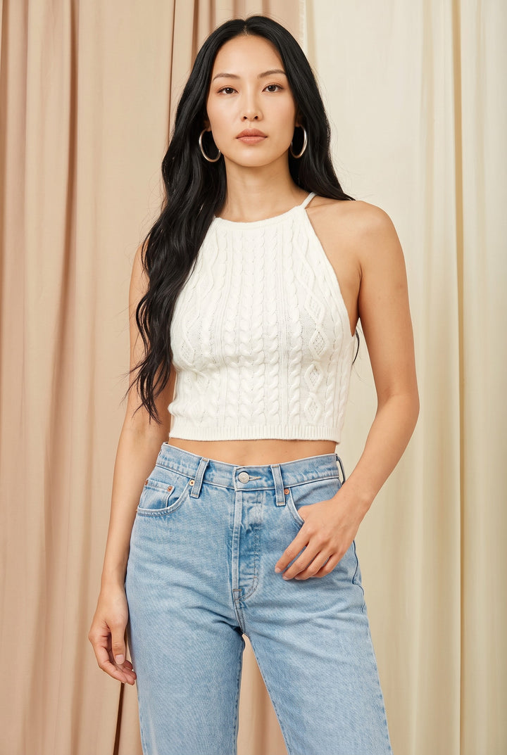 CAL JUNE white cable knit halter crop top with a structured bust and tie back detail. Model wears size S.